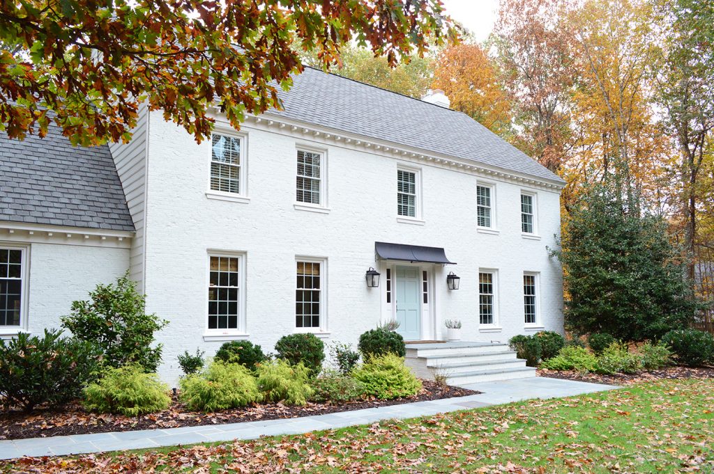 White Painted Brick Home With Modern Metal Portico Cover