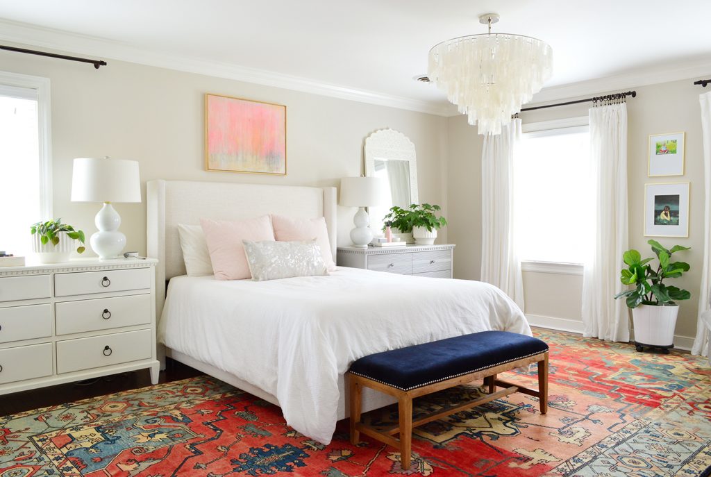 Traditional bedroom with Ikea curtains and red rug