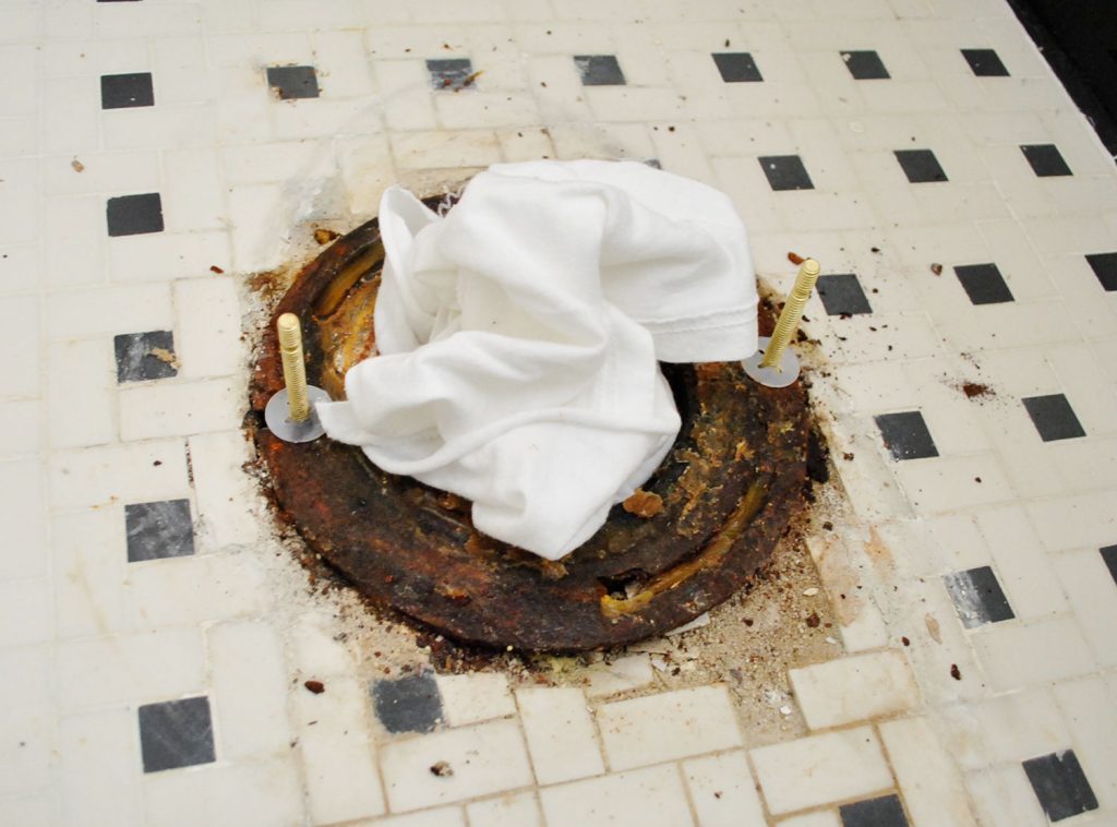 New Bolts On Toilet Flange With Rag In Sewer Hole
