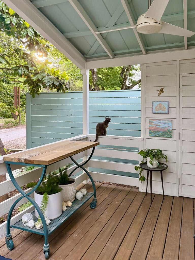 Cat Sitting On Railing Of Front Porch