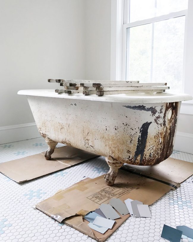 Dirty outside of clawfoot tub with rust stains