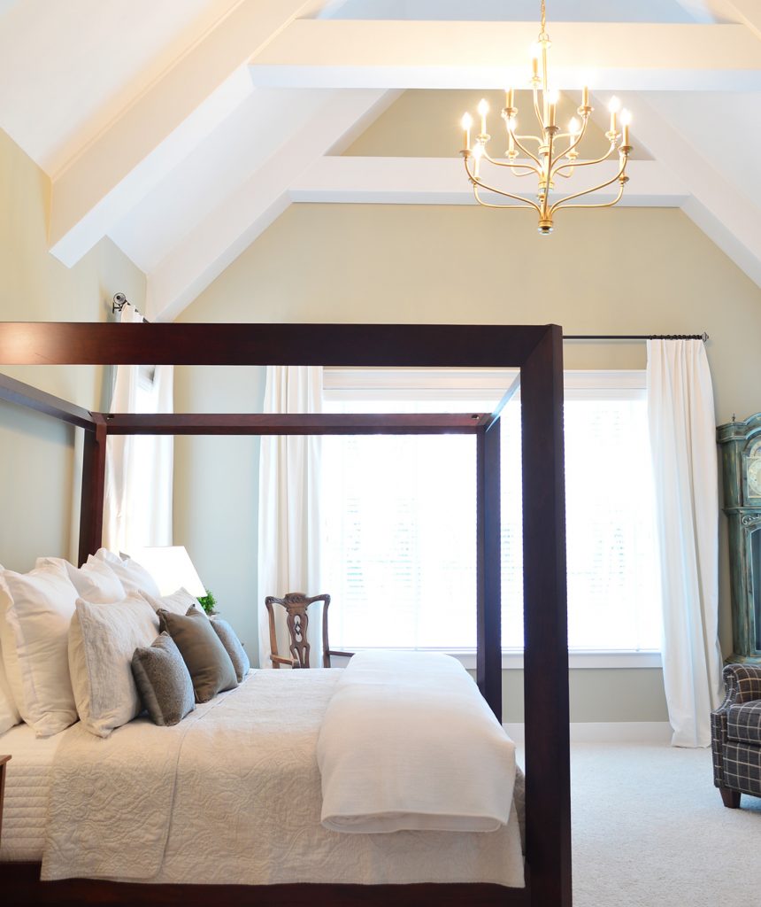 Room with large lofted ceiling and curtains pushed to side
