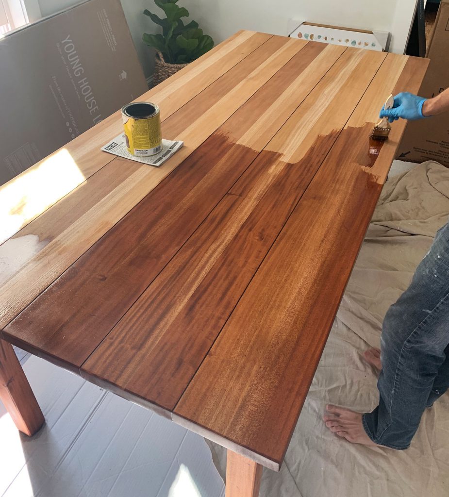 Minwax Stain Being Applied To Wood Dining Table During Refinishing