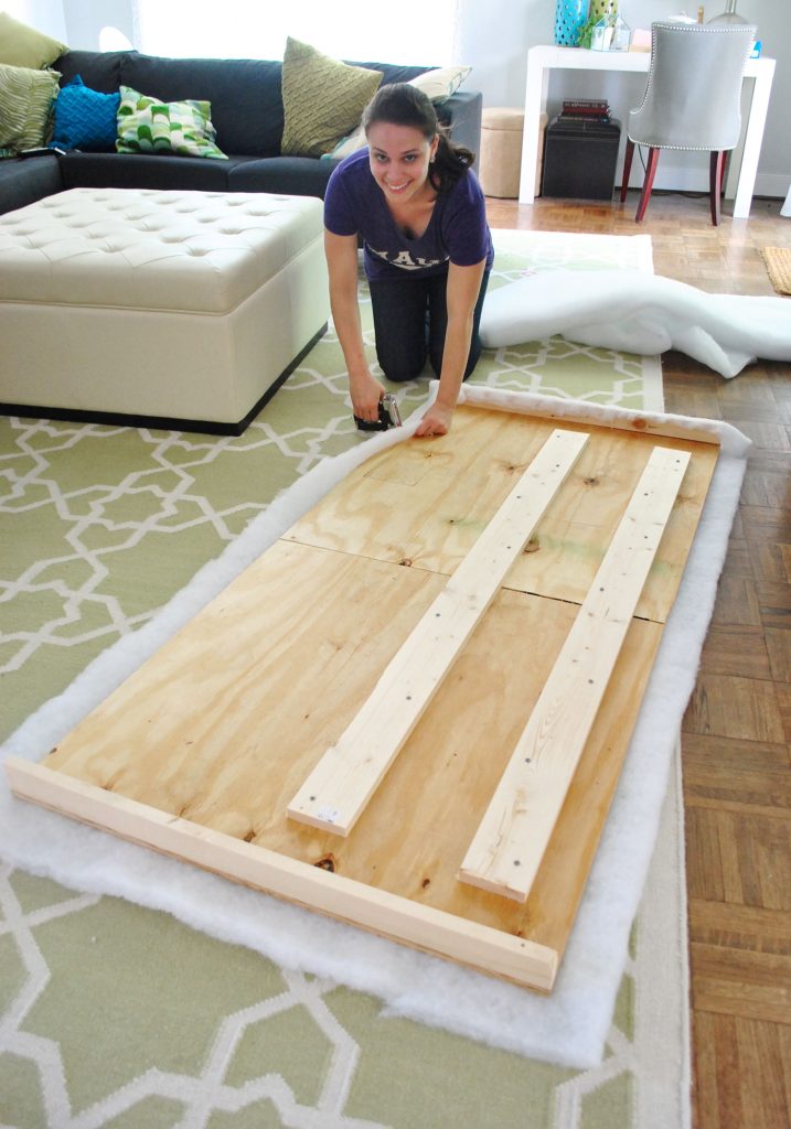 Sherry attaching batting to the back of a headboard frame