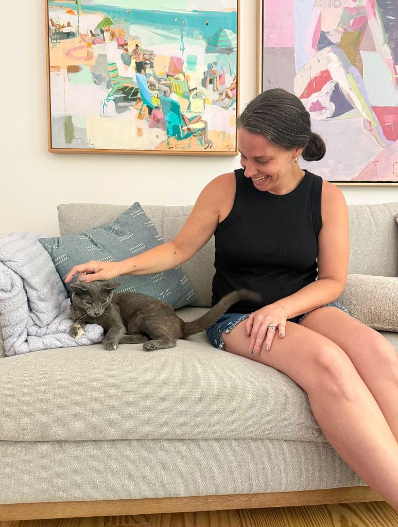 Sherry petting Jenny Cat On Couch Vertical Crop